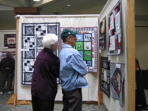 couple looking at quilts